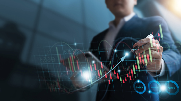 A person in a suit is analyzing a financial chart with upward trends and colored bars. They are using a stylus to mark points on the graph, indicating growth. The background is blurred, emphasizing the focus on the data display.