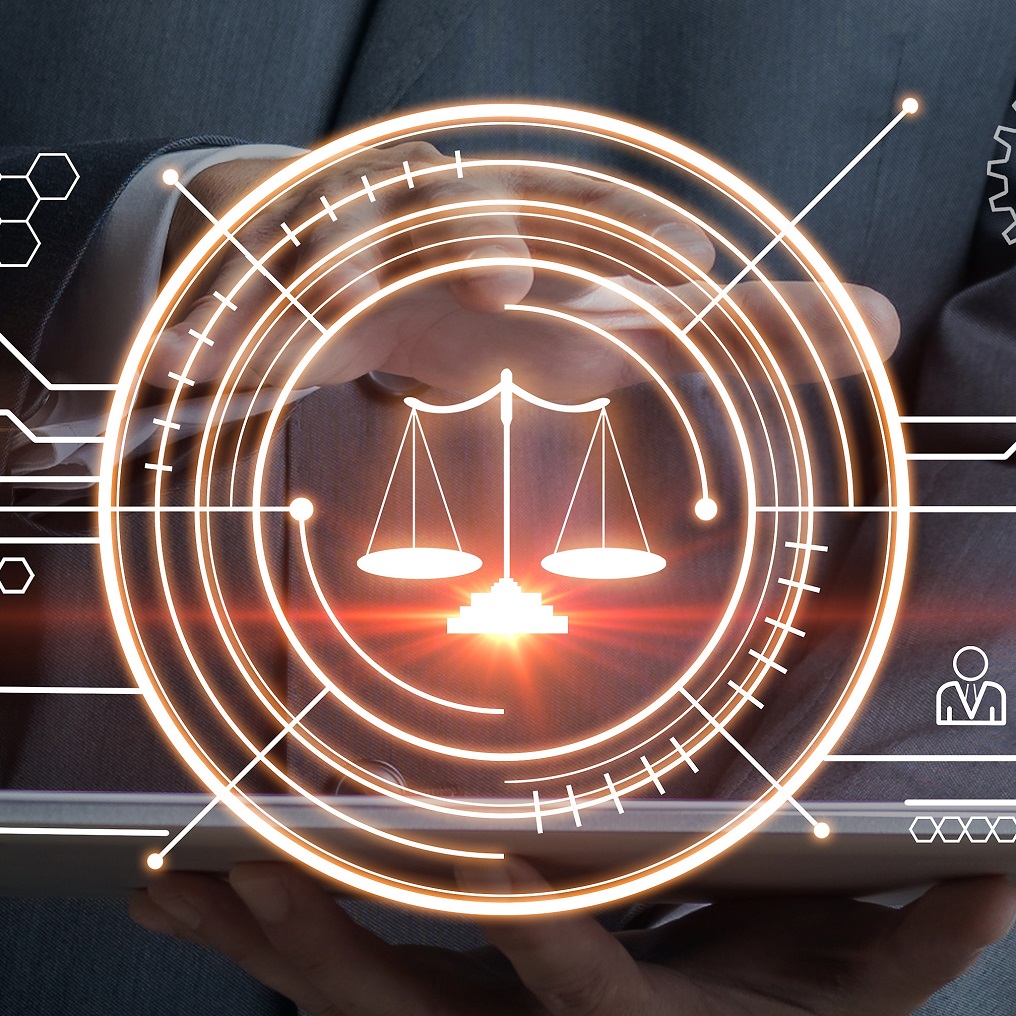 A person in business attire holds a tablet, with a glowing scales of justice symbol prominently displayed in the center. The image conveys themes of law, technology, and balance, suggesting an integration of legal principles with modern digital tools.