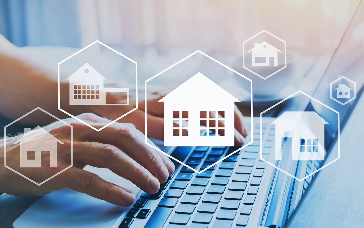 A person is typing on a laptop, surrounded by icons of various house designs. The image conveys themes of real estate and home-related services, illustrating the connection between technology and housing.