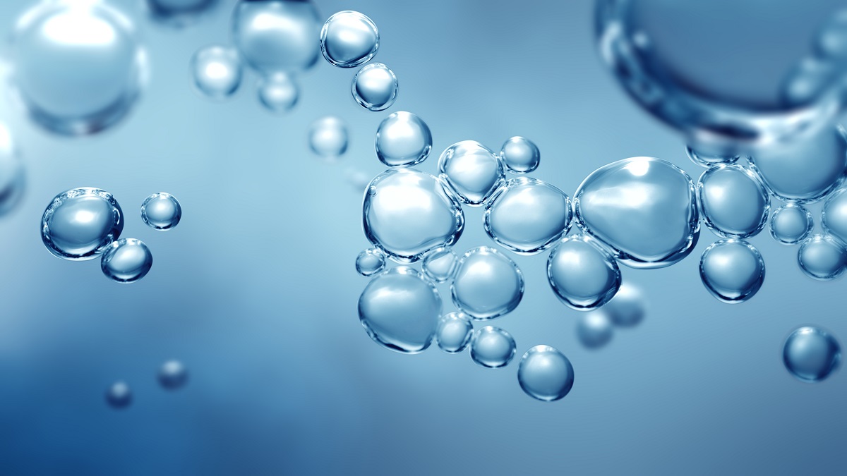 A close-up view of numerous clear, shimmering bubbles suspended in a soft blue background. The bubbles vary in size, creating a sense of depth and lightness, reminiscent of underwater scenes or effervescence.